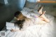 A woman laying on a bed reading a book.