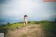 A naked woman standing on a dirt road with the word SMART.